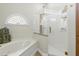 Bathroom featuring jacuzzi tub with elegant shower and frosted glass window at 1234 Harbor Town Way, Venice, FL 34292