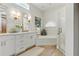 Well-lit modern bathroom with double vanity, jacuzzi tub and glass enclosed shower at 1234 Harbor Town Way, Venice, FL 34292