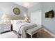Light blue bedroom with a crystal chandelier, closet and mounted flatscreen TV at 1234 Harbor Town Way, Venice, FL 34292