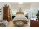 Bright bedroom featuring a large bed, shuttered windows, and elegant furnishings at 1234 Harbor Town Way, Venice, FL 34292