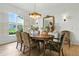 Elegant dining room with wood floors, statement lighting, and large windows at 1234 Harbor Town Way, Venice, FL 34292