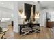 Hallway with decorative art, sconces, table, and view into the bright, modern kitchen at 1234 Harbor Town Way, Venice, FL 34292