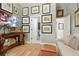 Hallway featuring framed art on the wall, wood floors, and a glimpse into the bathroom at 1234 Harbor Town Way, Venice, FL 34292