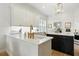 Kitchen features white cabinets, white countertops, stainless steel appliances, an island, and lots of natural light at 1234 Harbor Town Way, Venice, FL 34292