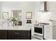 Modern kitchen with a large island, stainless steel appliances, white cabinets, and decorative tile backsplash at 1234 Harbor Town Way, Venice, FL 34292