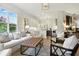Open-concept living space with a modern kitchen in the background and comfortable seating at 1234 Harbor Town Way, Venice, FL 34292