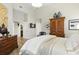 Comfortable main bedroom with beautiful hardwood floors, light gray walls and views to the bathroom at 1234 Harbor Town Way, Venice, FL 34292