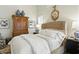 Beautiful main bedroom with great natural light and elegant armoire with blue and gray decorative pots at 1234 Harbor Town Way, Venice, FL 34292