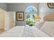 Main bedroom with view of lush outdoor gardens at 1234 Harbor Town Way, Venice, FL 34292