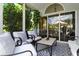 Screened patio with comfortable seating, black & white rug, and view to outdoor lounge chairs at 1234 Harbor Town Way, Venice, FL 34292