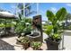 Outdoor patio with a fountain and lush landscaping, offering a serene outdoor space at 1234 Harbor Town Way, Venice, FL 34292