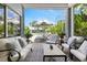 Screened patio with comfortable seating, black & white rug, overlooking the yard at 1234 Harbor Town Way, Venice, FL 34292