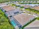 Aerial view showcasing homes with screened pools, solar panels, and manicured lawns in a lakeside community at 12404 Destin Loop, Venice, FL 34293