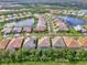 Real estate aerial view overlooking houses with backyard pools and serene lake views at 12404 Destin Loop, Venice, FL 34293