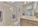 Bathroom features a glass shower, white tile and light gray vanity with white countertop at 12404 Destin Loop, Venice, FL 34293