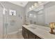 Bathroom with a light gray walls, a large white countertop vanity, and glass enclosed shower at 12404 Destin Loop, Venice, FL 34293
