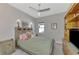 Bedroom features a plaid bedspread, neutral walls and ceiling fan at 12404 Destin Loop, Venice, FL 34293