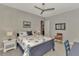 Comfortable bedroom featuring a full bed, a desk, and gray walls at 12404 Destin Loop, Venice, FL 34293