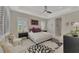 Bright main bedroom features a tray ceiling, ample natural light, and a contemporary design at 12404 Destin Loop, Venice, FL 34293