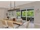 Dining room features a modern chandelier and seamless flow to the outdoor living area at 12404 Destin Loop, Venice, FL 34293