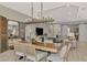 Dining area features a modern chandelier and views of the living room and kitchen at 12404 Destin Loop, Venice, FL 34293