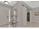 Bright entryway featuring a sliding barn door, a decorative mirror, and a stylish console table at 12404 Destin Loop, Venice, FL 34293