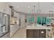 Modern kitchen flows into the dining area, featuring an island, sleek countertops and stainless steel appliances at 12404 Destin Loop, Venice, FL 34293