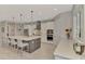 Modern kitchen features an island with seating, stainless steel appliances, and ample cabinet space at 12404 Destin Loop, Venice, FL 34293