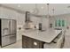 Well-equipped kitchen featuring stainless steel appliances, a spacious island, and ample counter space for cooking at 12404 Destin Loop, Venice, FL 34293