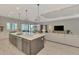 Open-concept kitchen featuring a large island and seamless flow into the living and dining spaces at 12404 Destin Loop, Venice, FL 34293