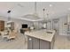 Wide open-concept space with kitchen island that opens to the dining area and living space at 12404 Destin Loop, Venice, FL 34293