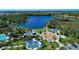 Scenic aerial shot of community lake, splashpad, playground, tennis courts, and common area at 12404 Destin Loop, Venice, FL 34293