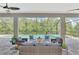 Relaxing screened in lanai with outdoor seating overlooking the pool and lush greenery at 12404 Destin Loop, Venice, FL 34293