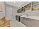 Laundry room with modern washer and dryer, cabinets, sink and wooden bench at 12404 Destin Loop, Venice, FL 34293