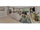 Spacious living room featuring an open layout to the kitchen and dining area, with light wood floors and modern decor at 12404 Destin Loop, Venice, FL 34293