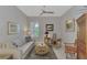 Neutral living room featuring a sofa, desk, and gray walls at 12404 Destin Loop, Venice, FL 34293