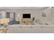 Bright living room features a comfortable sectional sofa, stylish furnishings, and decor at 12404 Destin Loop, Venice, FL 34293