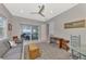 Living room shows a sofa, chairs, an area rug, table, and an opening to a dining area at 12404 Destin Loop, Venice, FL 34293
