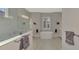Bright bathroom with a freestanding tub, large window, and modern fixtures at 12404 Destin Loop, Venice, FL 34293