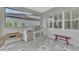 Outdoor kitchen features modern stainless steel appliances, countertop space and bench seating for casual outdoor dining at 12404 Destin Loop, Venice, FL 34293