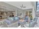 Covered patio boasts comfortable seating and seamless indoor-outdoor living with views to the home's interior at 12404 Destin Loop, Venice, FL 34293