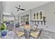 Wide view of the patio with tables, outdoor kitchen and sliding glass doors, offering the perfect entertaining space at 12404 Destin Loop, Venice, FL 34293