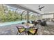 Screened-in patio with a pool and plenty of outdoor seating, next to lush landscaping at 12404 Destin Loop, Venice, FL 34293