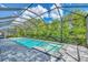 Screened-in pool with a spa and gray pavers that creates a refreshing outdoor oasis at 12404 Destin Loop, Venice, FL 34293