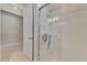Bathroom shower with glass door, light gray walls and a doorway to the rest of the bathroom at 12404 Destin Loop, Venice, FL 34293