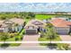 An aerial view shows the house, beautiful landscaping, and surrounding community at 13092 Rinella St, Venice, FL 34293