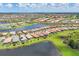 Aerial view of the community with pools, lakes, and surrounding landscaping at 13092 Rinella St, Venice, FL 34293