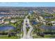 Gorgeous aerial view of an upscale neighborhood, showcasing the beautiful landscaping and tranquil lakes at 13092 Rinella St, Venice, FL 34293
