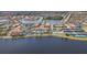 Stunning aerial view of community featuring a pool, tennis courts, clubhouse, waterways, and landscaped surroundings at 13092 Rinella St, Venice, FL 34293