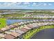 Stunning aerial view of lakeside homes in a beautiful community with lush landscaping and blue skies at 13092 Rinella St, Venice, FL 34293